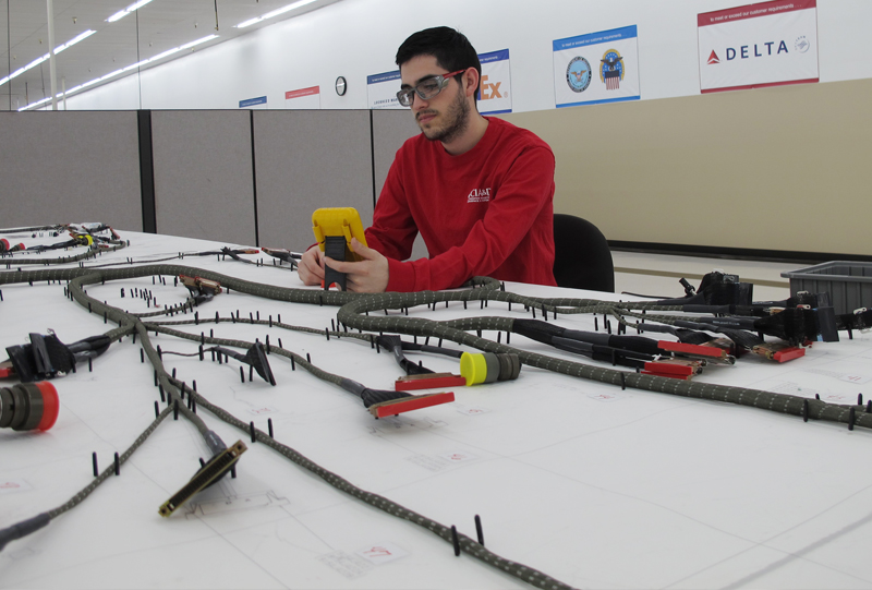 Man inspecting connector products